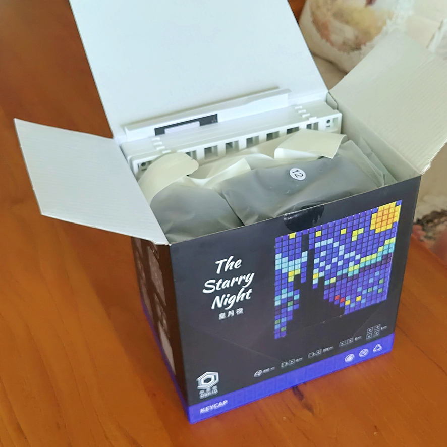 Keycap art box showing five masterpiece designs