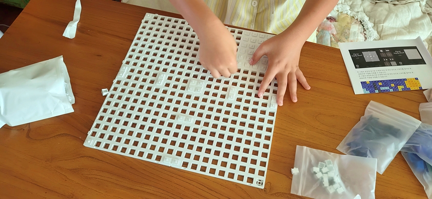 Inserting cross stems into the white baseplate grid