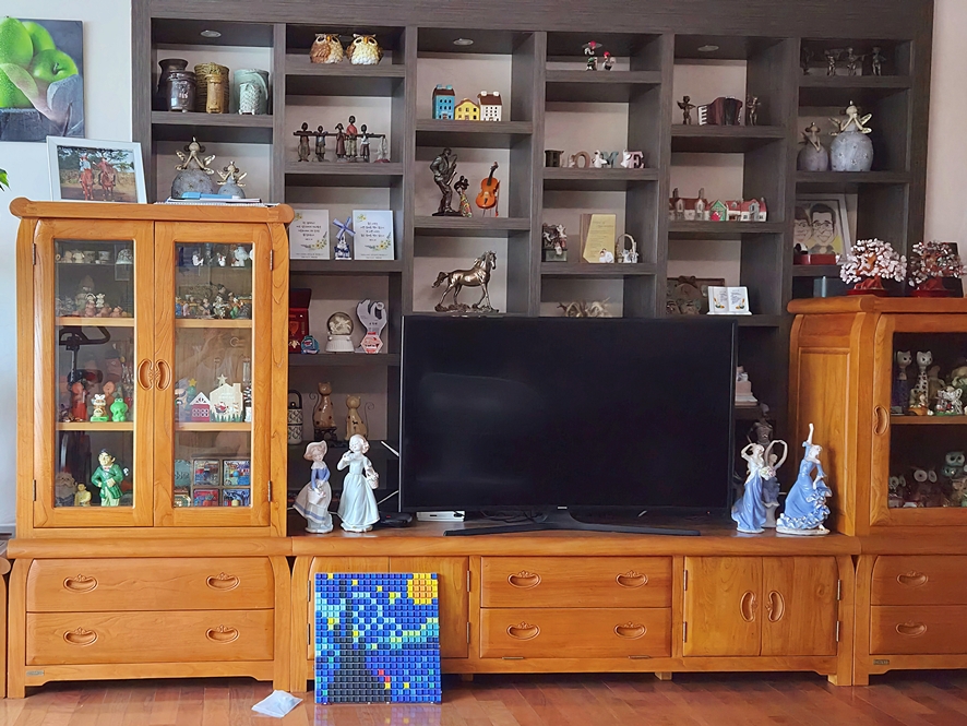 Finished keycap art displayed under the living room TV