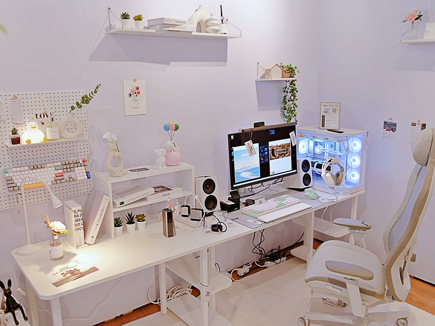 Black themed desk setup with wall mounted display